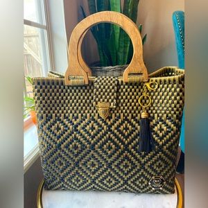 Women’s new black and gold woven handbag with wooden handles.